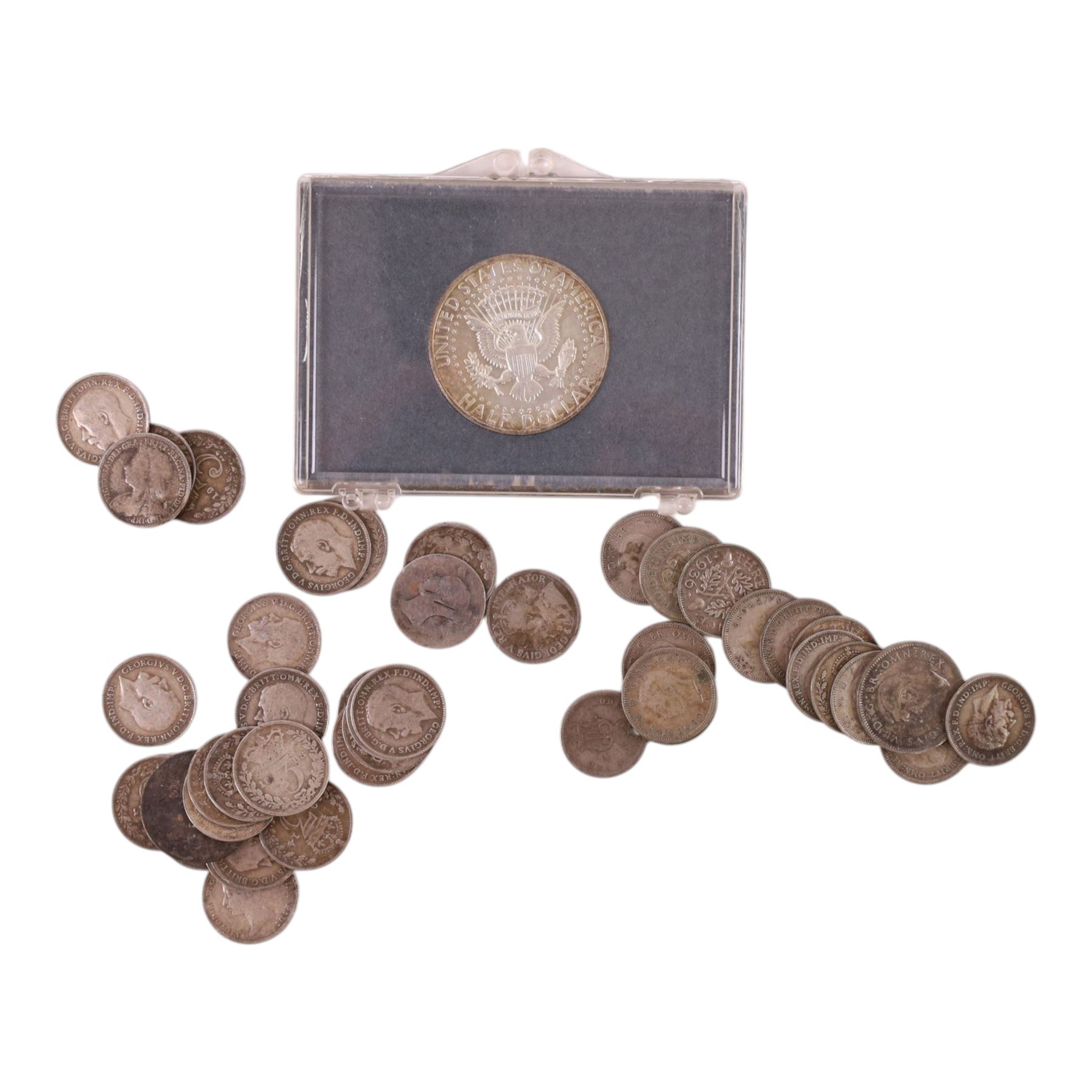 Approximately 39 grams of Great British pre-1920 and approximately 22 grams of Great British pre-1947 silver coins, mainly threepences, together with a United States of America 1964 'Kennedy' silver half dollar and two small silver coins