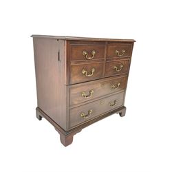 George III mahogany commode chest, hinged top and front, disguised with false drawers, on bracket feet