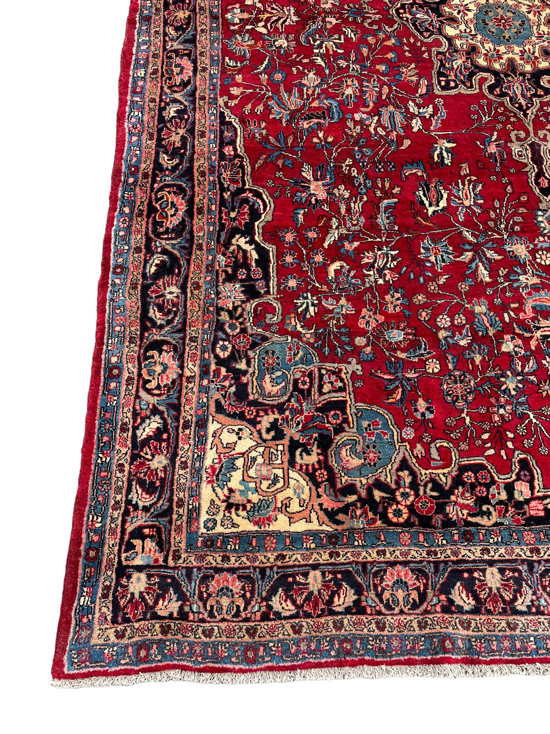 North West Persian Bidjar red ground carpet, shaped pole medallion surrounded by interlacing branches and stylised flower heads, five band border with repeating floral design