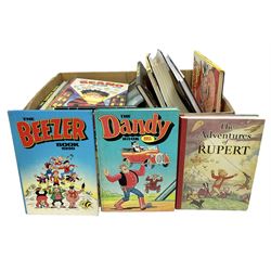 Quantity of children's annuals and books to include two copies of Daily Express The Adventures of Rupert 1939 Facsimile 1991, 1980s and later Knockout, Beano, Dandy, Beezer etc