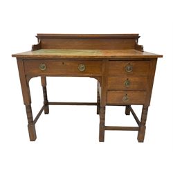 Early 20th century oak writing desk, raised back over rectangular top with inset leather writing surface, fitted with four drawers, raised on ring turned supports
