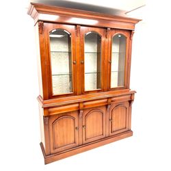 Waring & Gillow three door bookcase on cupboard, illuminated interior with hinge touch control, three bevel edged glazed cupboard doors enclosing nine adjustable shelves, three drawers above three cupboards, platform base
