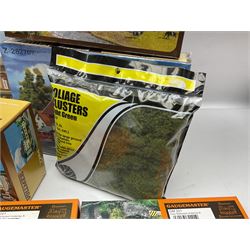 'N' gauge trackside accessories - seven Faller buildings and bridges etc Nos.N212113, N222121, N222583, N222174, N222128, Z282730 & Z282707; two others by Vollmer Nos.N7657 & N7724; four boxes of Gaugemaster Ballasted Underlay; grit and Foliage Clusters