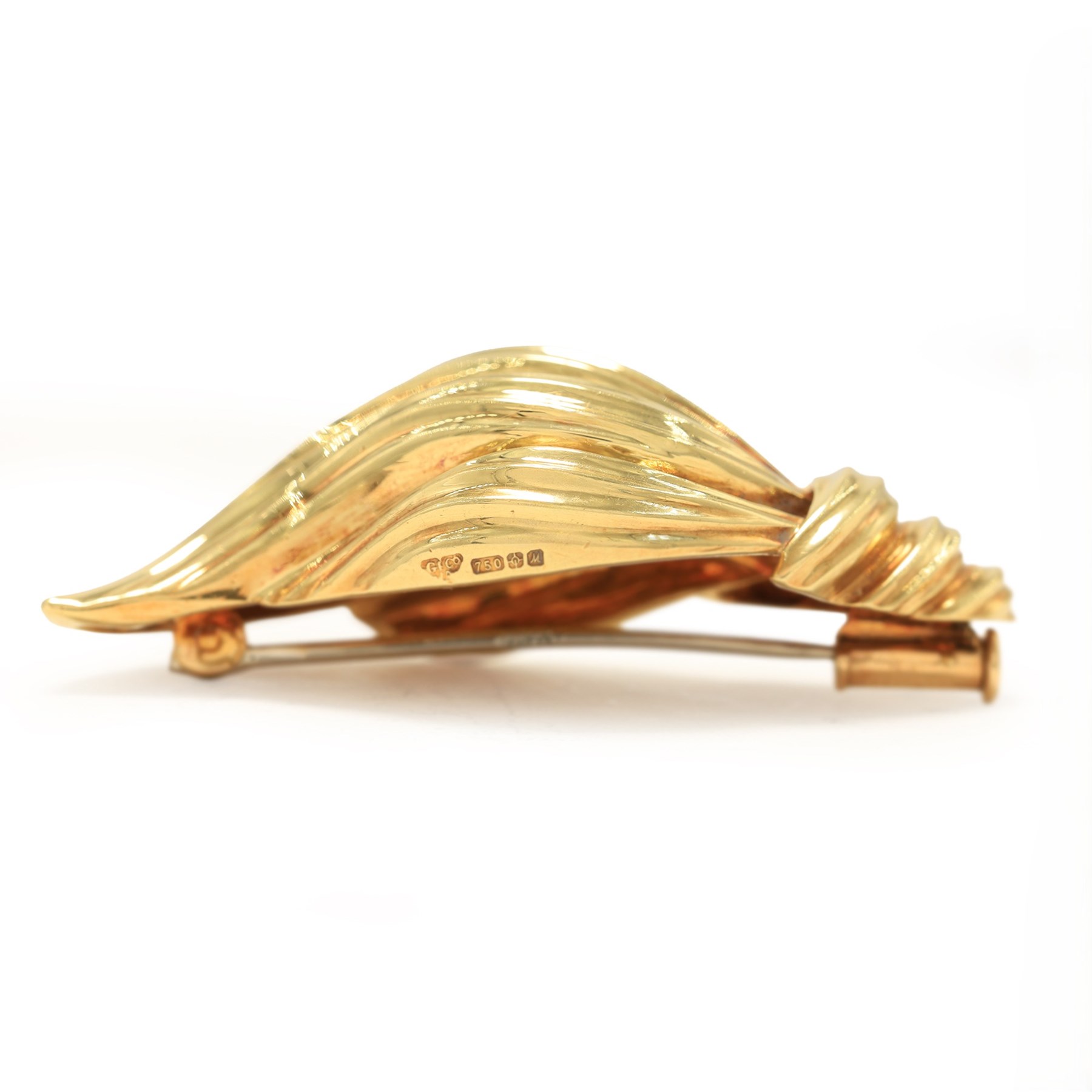 18ct gold abstract 'Flame' brooch designed by Henry Dunay for Garrard, London import mark 1986, boxed with receipt