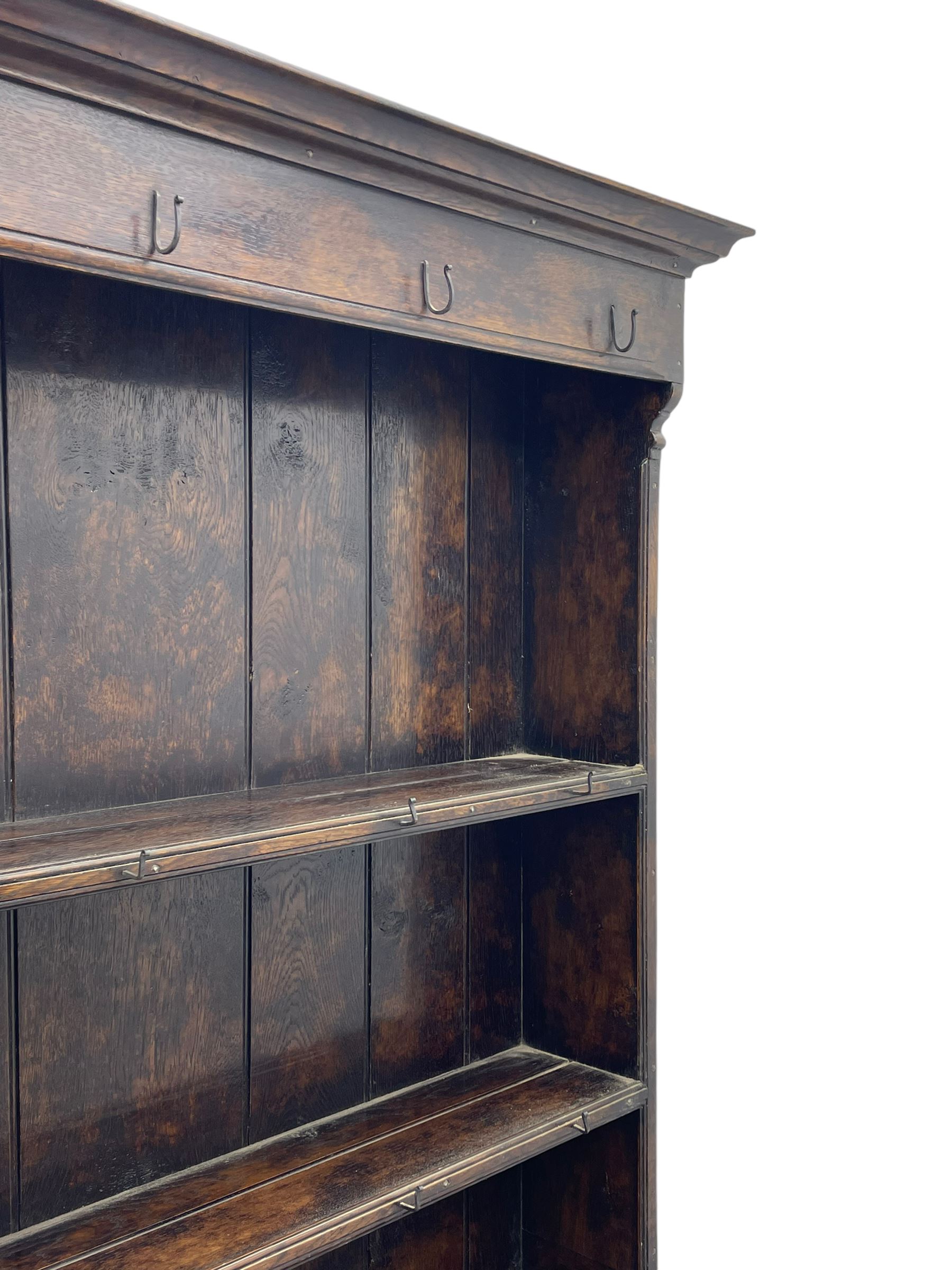 Bylaws of Leominster - 18th century design figured oak dog kennel dresser, the raised plate rack with projecting cornice over hooks and three tiers, moulded rectangular top over three drawers and two panelled cupboards, moulded frame and panelled sides, on stile supports