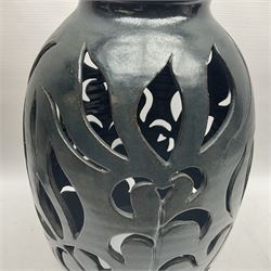 John Egerton (c1945-): studio pottery stoneware lamp base, decorated with pierced floral decoration with a dark blue ground, together with Edinbane Pottery plant stand and two other studio pottery items, lamp base H56cm