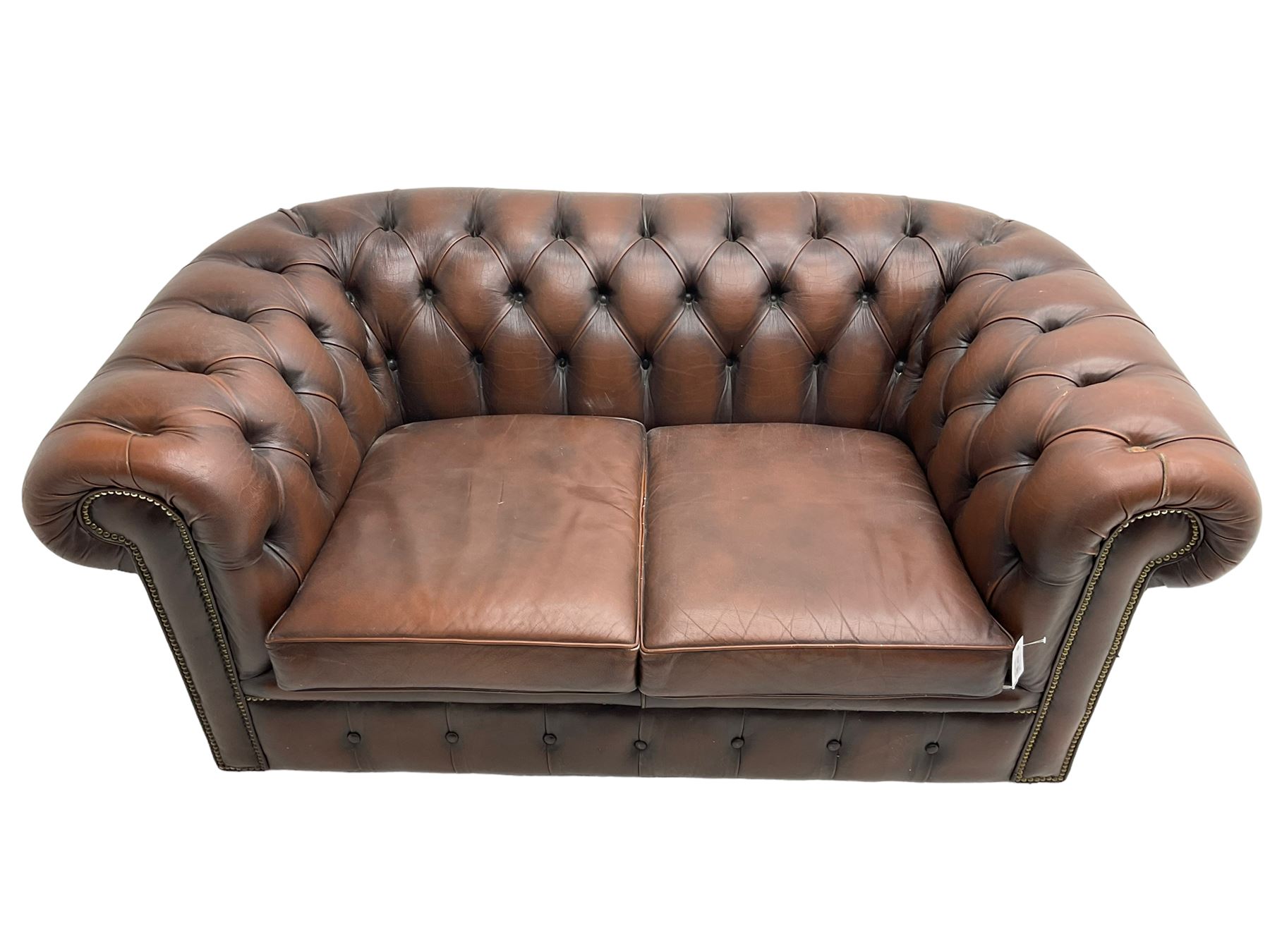 Chesterfield two seat sofa, upholstered in brown buttoned leather