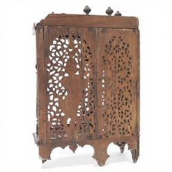 20th century Indian carved hardwood corner shelf, the tiered pagoda form with pierced and carved foliate panels centred by figural carving, supported by turned and carved columns, with shaped brackets and pendant finials
