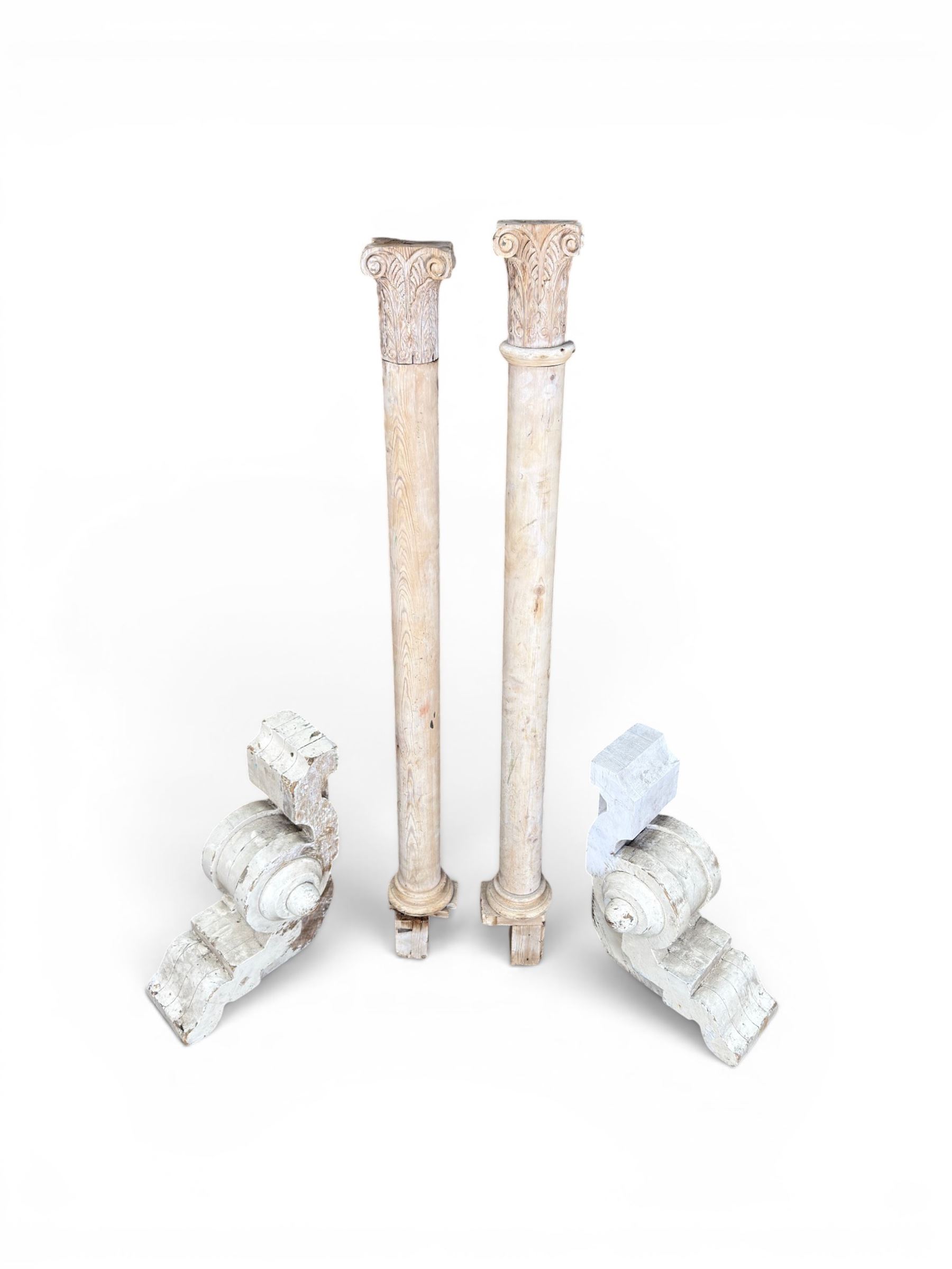 Pair of 19th century stripped pine columns  with carved capitols; an a pair of painted scroll architectural capitols (4)