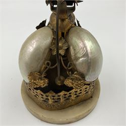 Victorian evening dinner bell, with three mother of pearl shells, floral and grape gilt decoration, and bird finial, raised upon a circular soapstone base with gilt pierced gallery, H14cm