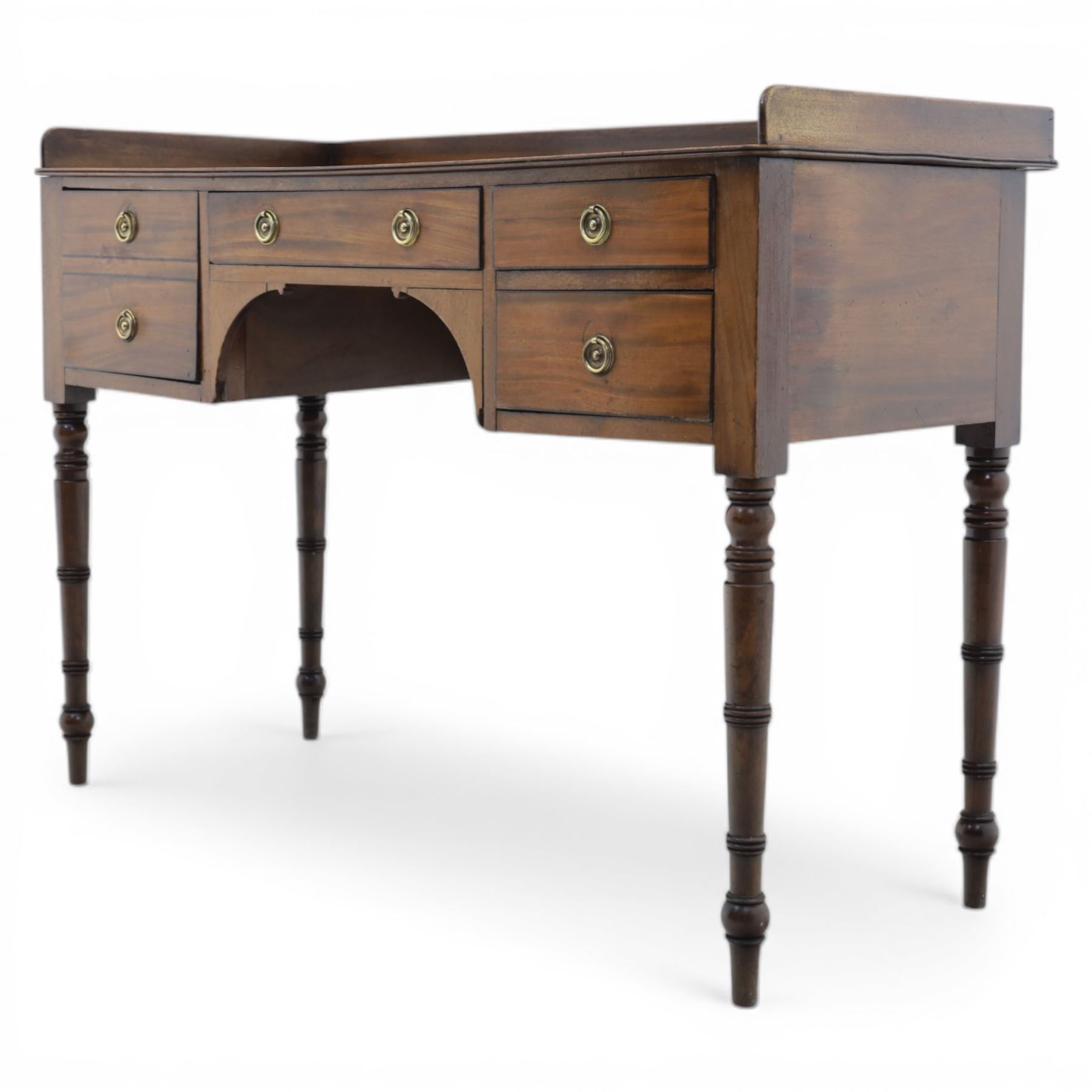 Late Georgian mahogany sideboard, circa 1820, the rectangular top with gallery, above an arrangement of four drawers with brass ring handles, one double height drawer to the left, a central single frieze drawer, and two drawers to the right, upon turned legs