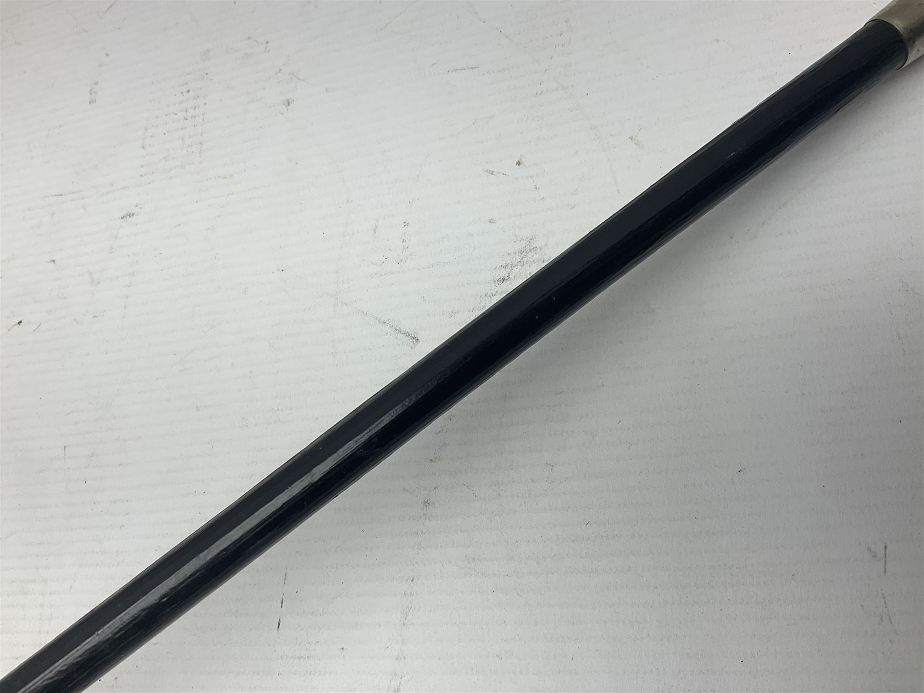 Brown Bess type socket bayonet the 40.5cm fullered triangular blade stamped WK, L52.5cm overall; malacca cane swagger type stick with white metal mounts and horse hair fly whisk; and another plain ebonised swagger stick (3)