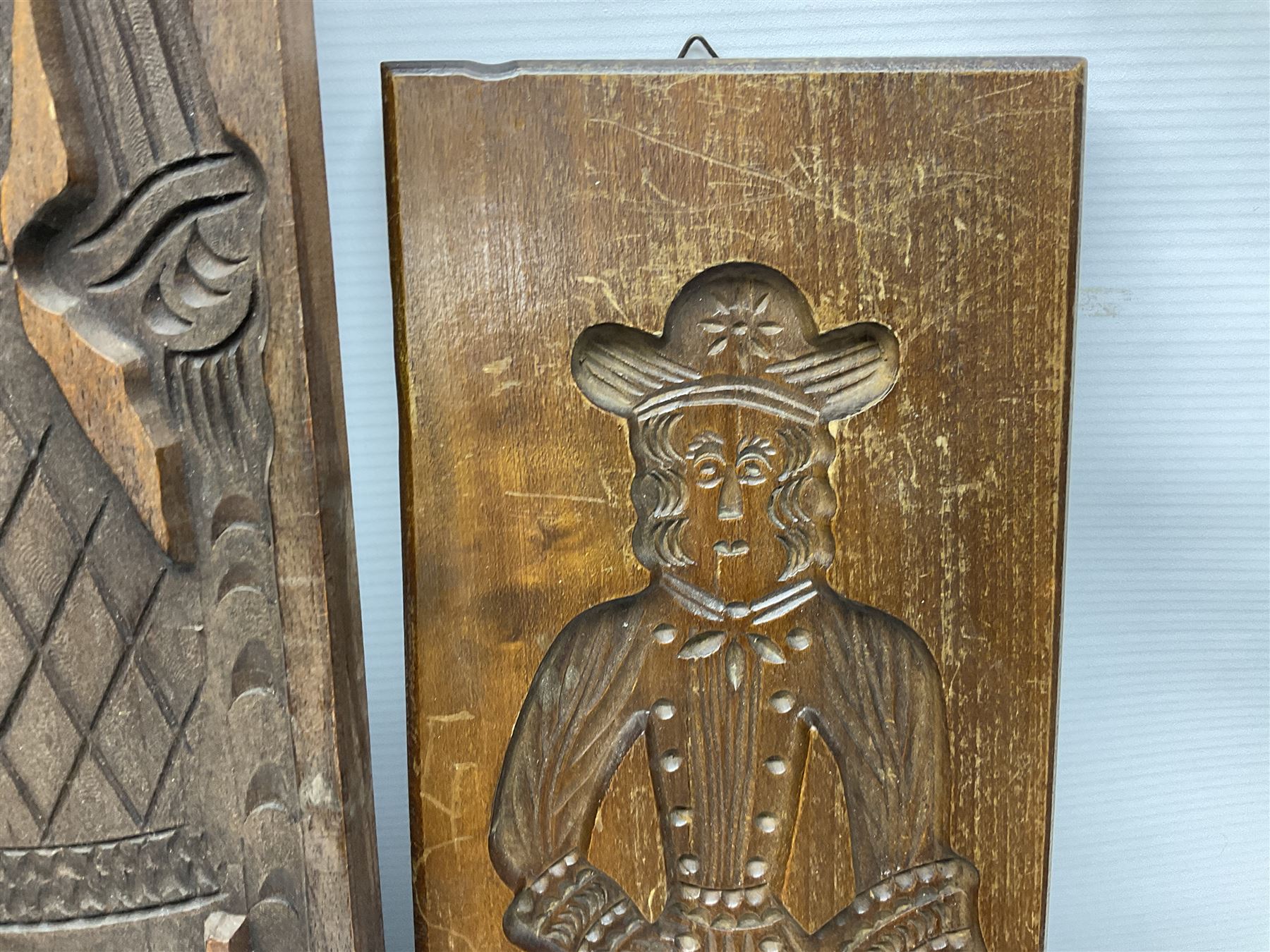 Six 20th century hardwood Dutch folk art Speculaasplank or biscuit moulds, typically carved with figures in traditional dress, largest H101cm