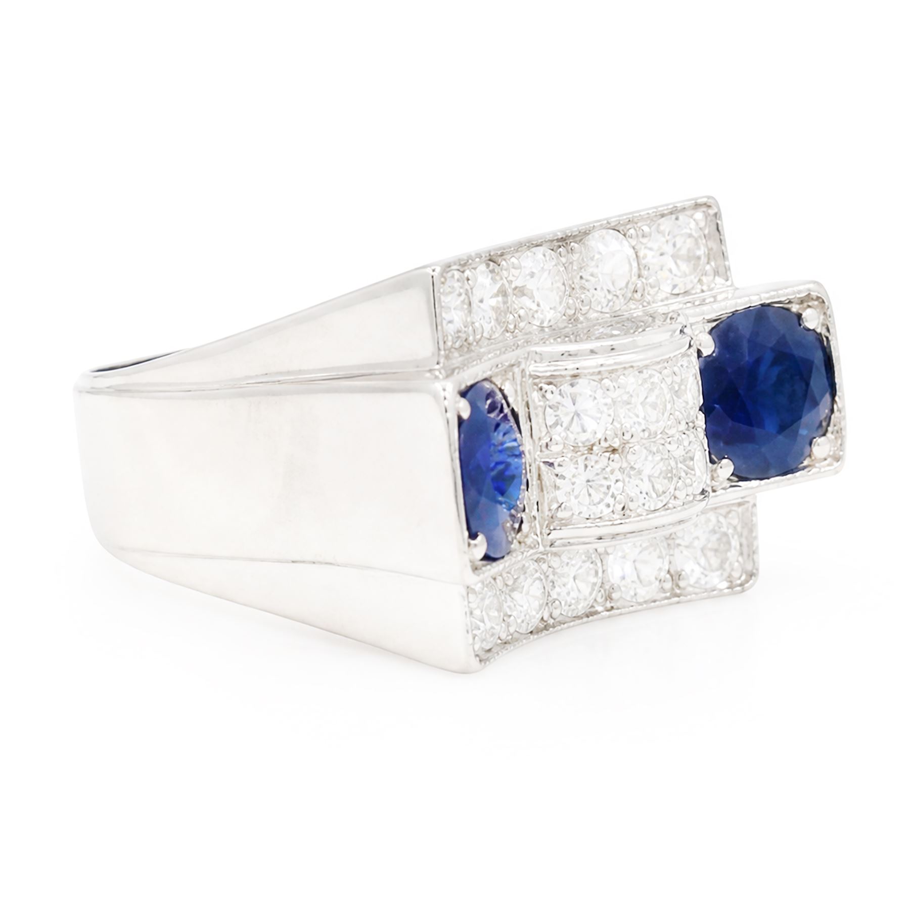 Platinum sapphire and diamond abstract design dress ring, pave set with eighteen old cut and round brilliant cut diamonds, with two mixed cut sapphires at each end, in a curved design setting, total sapphire weight approx 2.68 carat, total diamond weight approx 1.95 carat, with World Institute Report