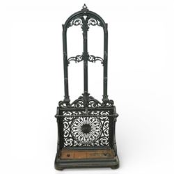 Late 19th century cast iron stick stand, the arched back with scrolling foliate decoration...
