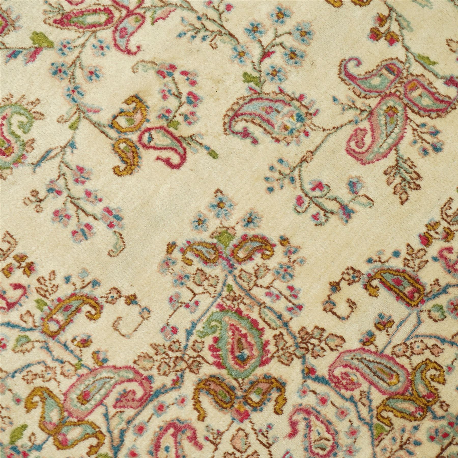 Persian Isfahan cream ground rug, overall floral design, sparse field decoration with trailing flower head and Boteh motifs, repeating floral pattern boarder with repeating motifs 
