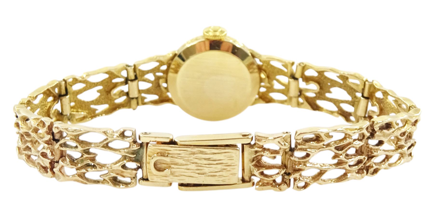 Omega ladies 9ct gold manual wind wristwatch, Ref. 7115674, silvered dial with baton hour markers, on 9ct gold pierced design bracelet, London 1972, with guarantee dated 1973