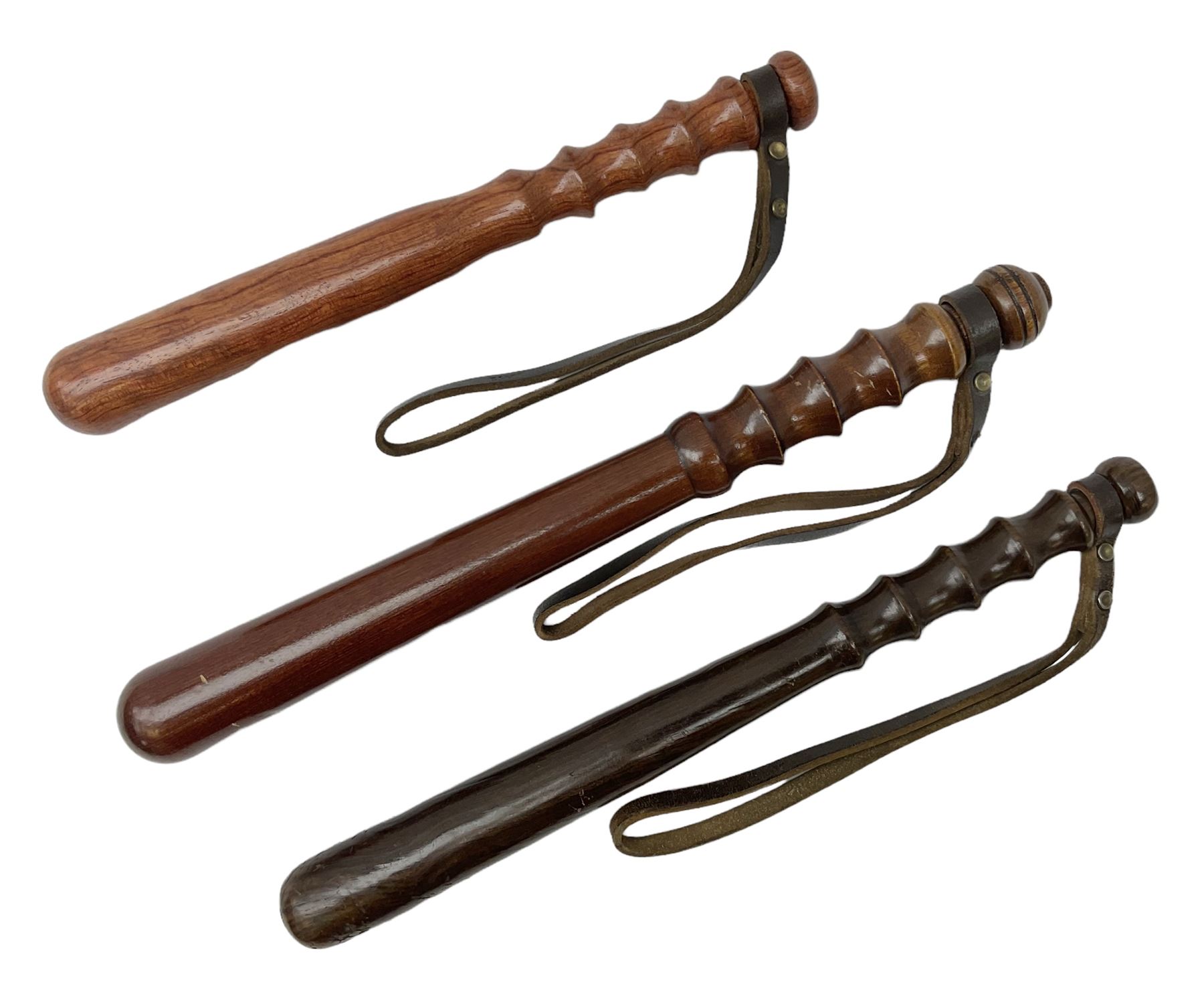 Three police turned hardwood truncheons comprising two patrol truncheons and WPC short truncheon (3)