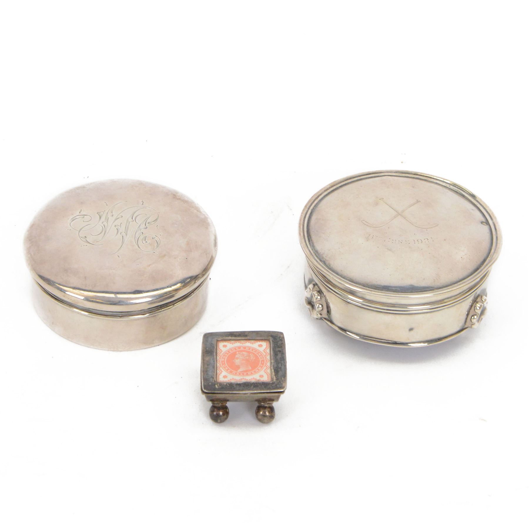Silver stamp box, the hinged cover with glazed stamp panel, upon four bun feet, stamped 925, together with 1920's silver jewellery box of circular form with engraving to the lid, hallmarked 1920 Birmingham, indistinct maker and covered box with engraving to the lid, hallmarked probably William Harrison Walter 1907, London     