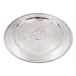 Modern limited edition silver salver, celebrating the achievements of Grundy, champion racehorse of 1975, each of circular form with gadrooned rim and plaque to centre depicting jockey mounted upon Grundy, designed by Stuart Devlin, limited edition no. 15/500, hallmarked London 1976, makers mark LH, D23cm, within silver lined fitted box and limited edition certificate 