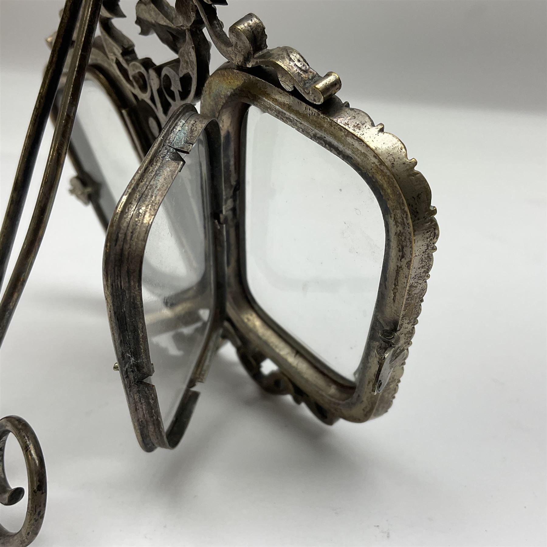 Early 19th century silver plated double photograph frame, each rounded rectangular aperture surrounded by a paste border, with ornate scroll feet and mantling also set with clear paste stones, with easel style support verso, H12cm