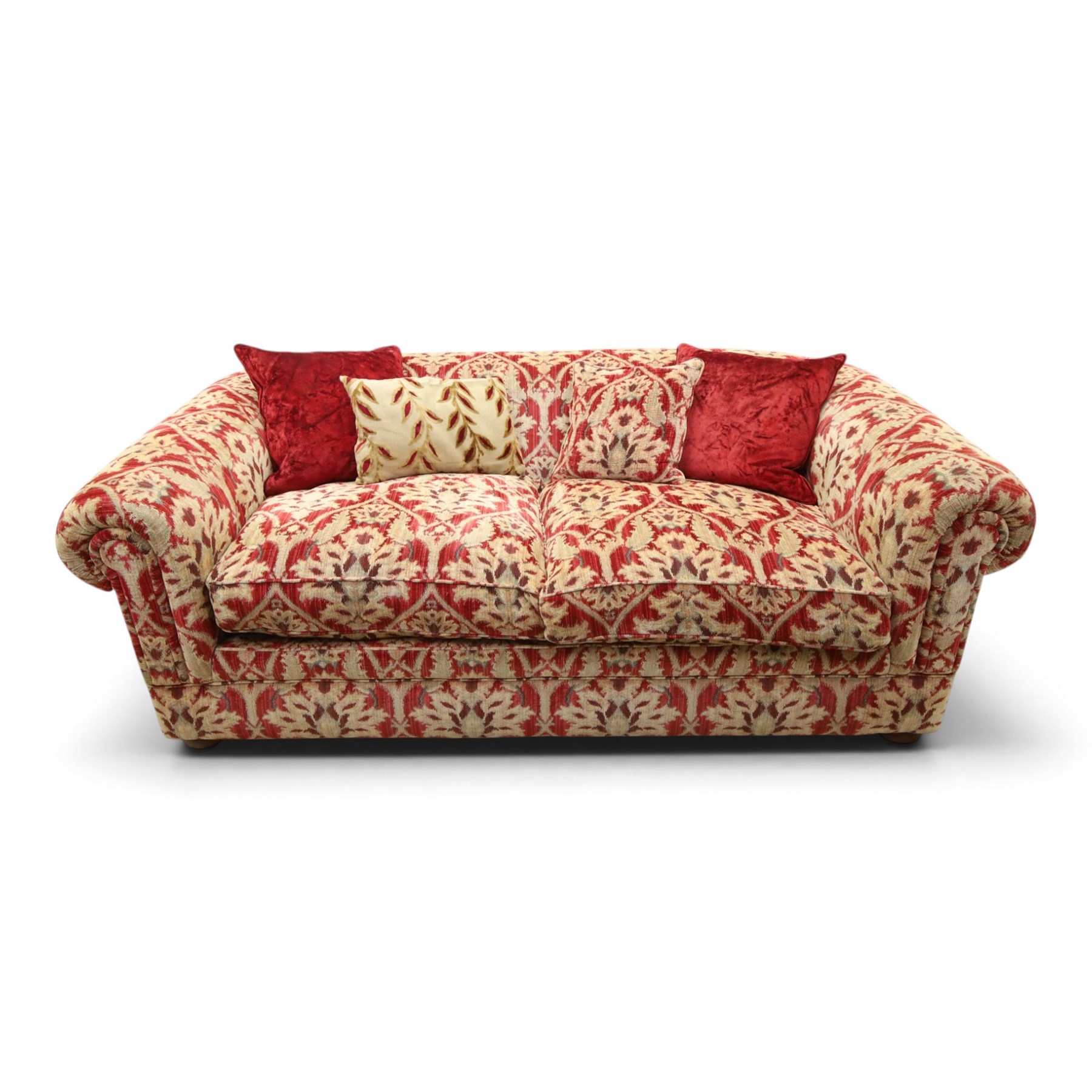 Tetrad - grande two seat 'Elgar' sofa of traditional Chesterfield shape with rolled arms, upholstered in red and gold foliate patterned fabric with matching loose and scatter cushions, on compressed bun feet