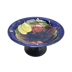 Moorcroft small pedestal dish decorated in the Wisteria pattern against a dark blue ground raised to a Tudric pewter stand, impressed beneath Tudric, Moorcroft, H9cm