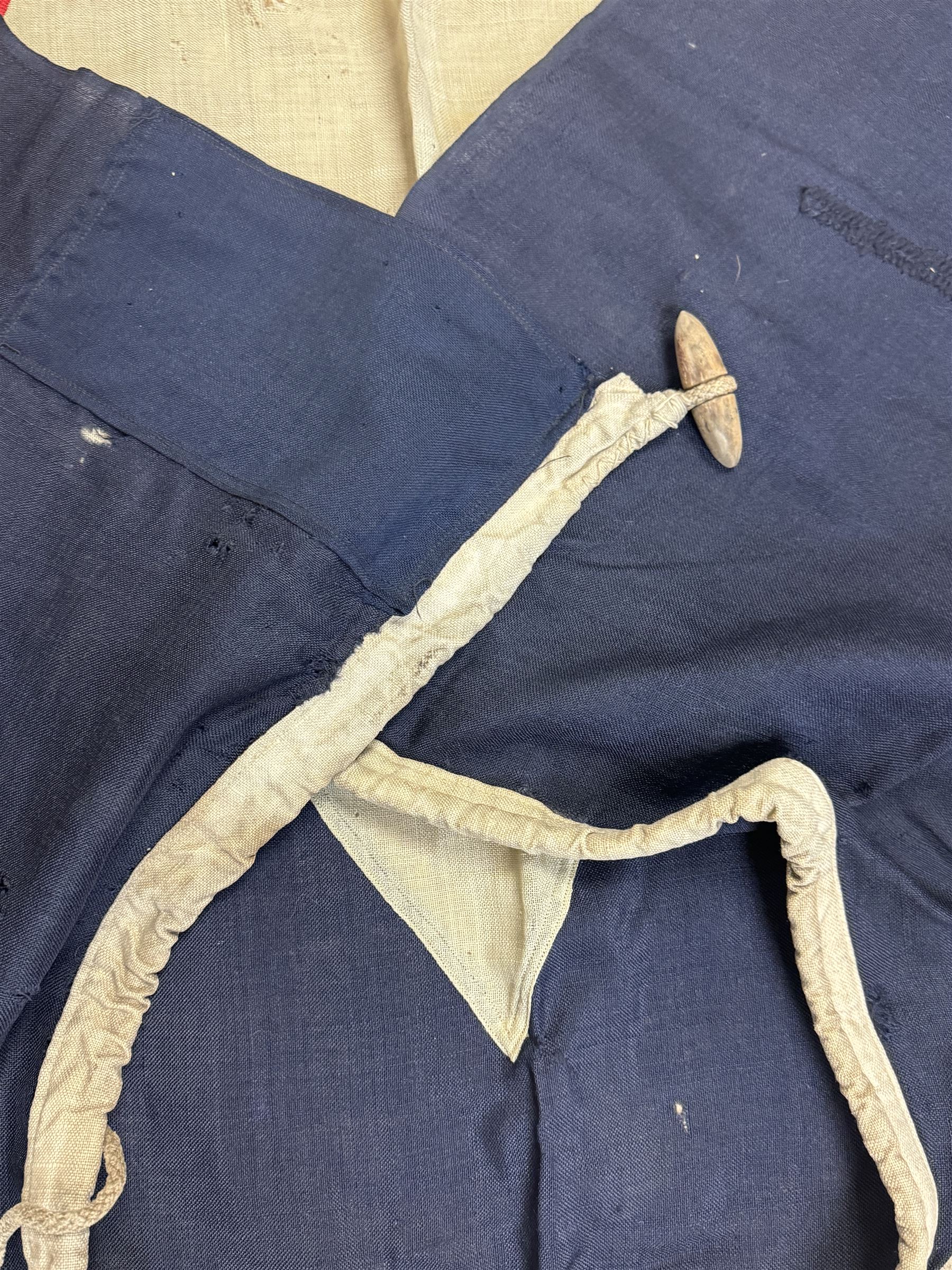 Ship's house flag, rectangular linen flag, with a white diamond and red cross to the centre, upon a cobalt blue ground, inscribed on the hoist 'Cutty Sark', H130cm, W170cm

Provenance by vendor repute: Vendor's father was a naval cadet in 1940s/50s on board HMS Worcester which was moored alongside the Cutty Sark on the River Thames at Greenhithe. He has had the flag since then. 
