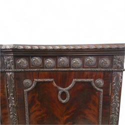Edwardian mahogany serpentine breakfront display cabinet in the neoclassical style, the rectangular top above a carved frieze with roundels, foliage, and ribbon tied swags with central bow-fronted astragal glazed doors enclosing shelves, flanked by panelled doors, raised on bracket feet 