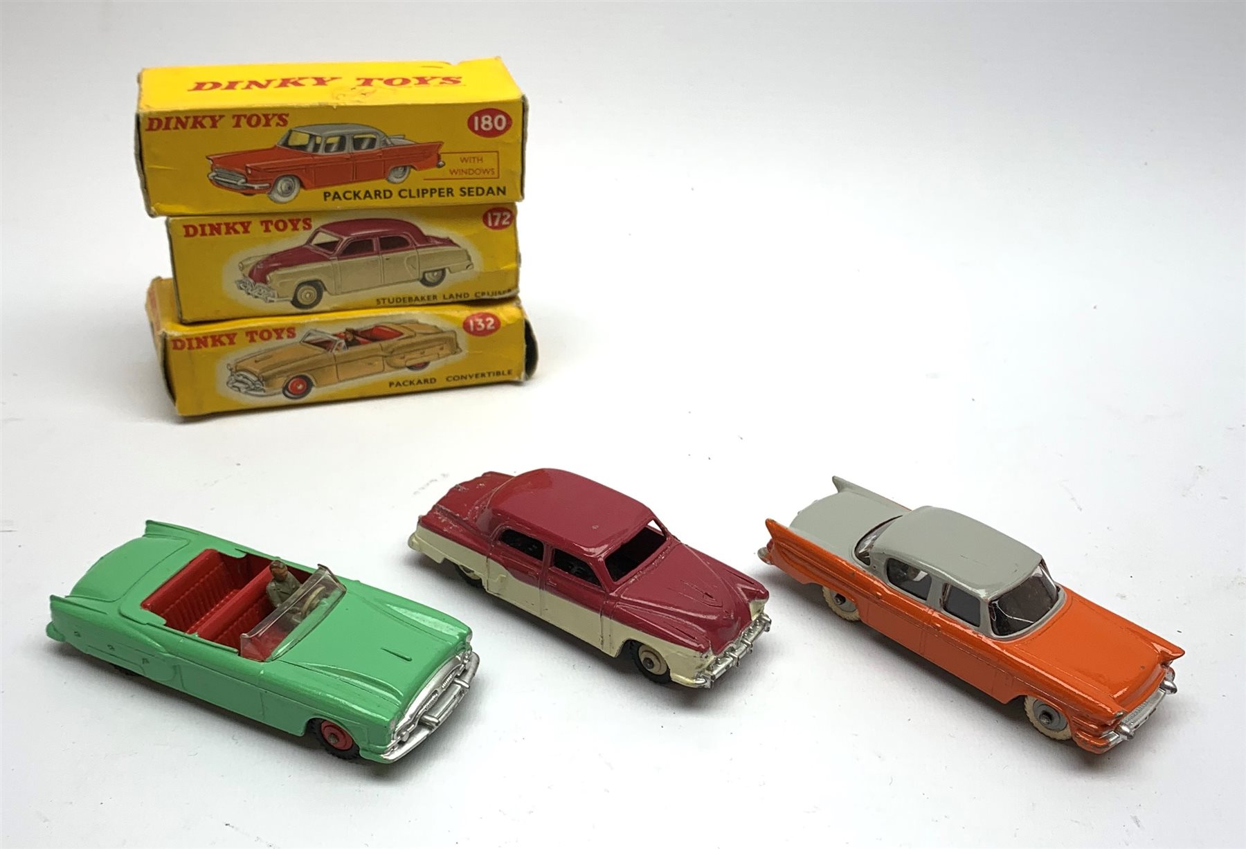 Dinky - Packard Convertible No.132, Packard Clipper Sedan with windows No.180 and Studebaker Land Cruiser No.172, all boxed (3)