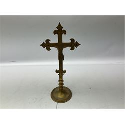 Brass crucifix depicting Christ on the cross, the arms terminating with fleur-de-lis, raised upon circular base, H41cm