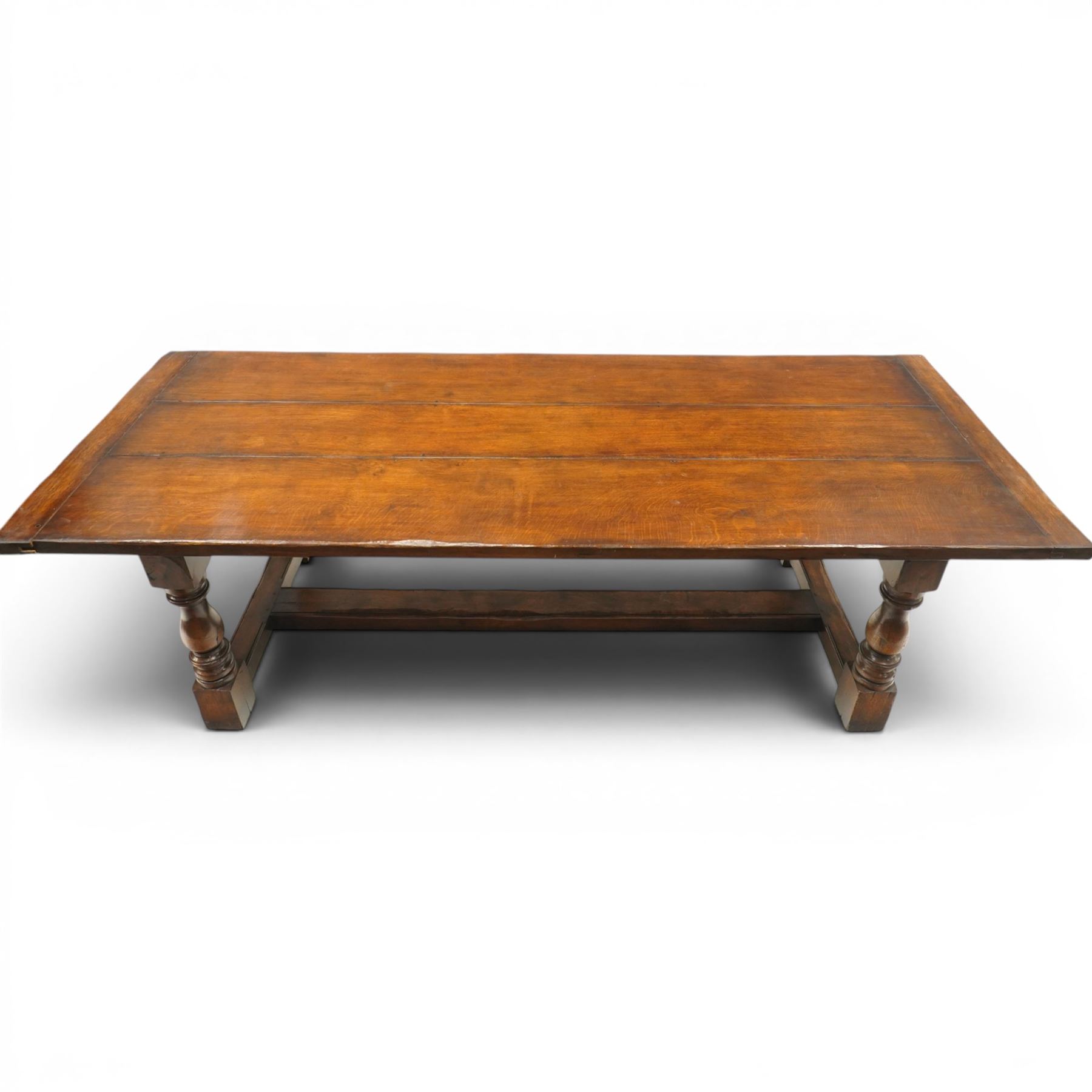17th century design 8ft dark oak refectory dining table, the rectangular top raised on four turned baluster supports united by H-stretcher