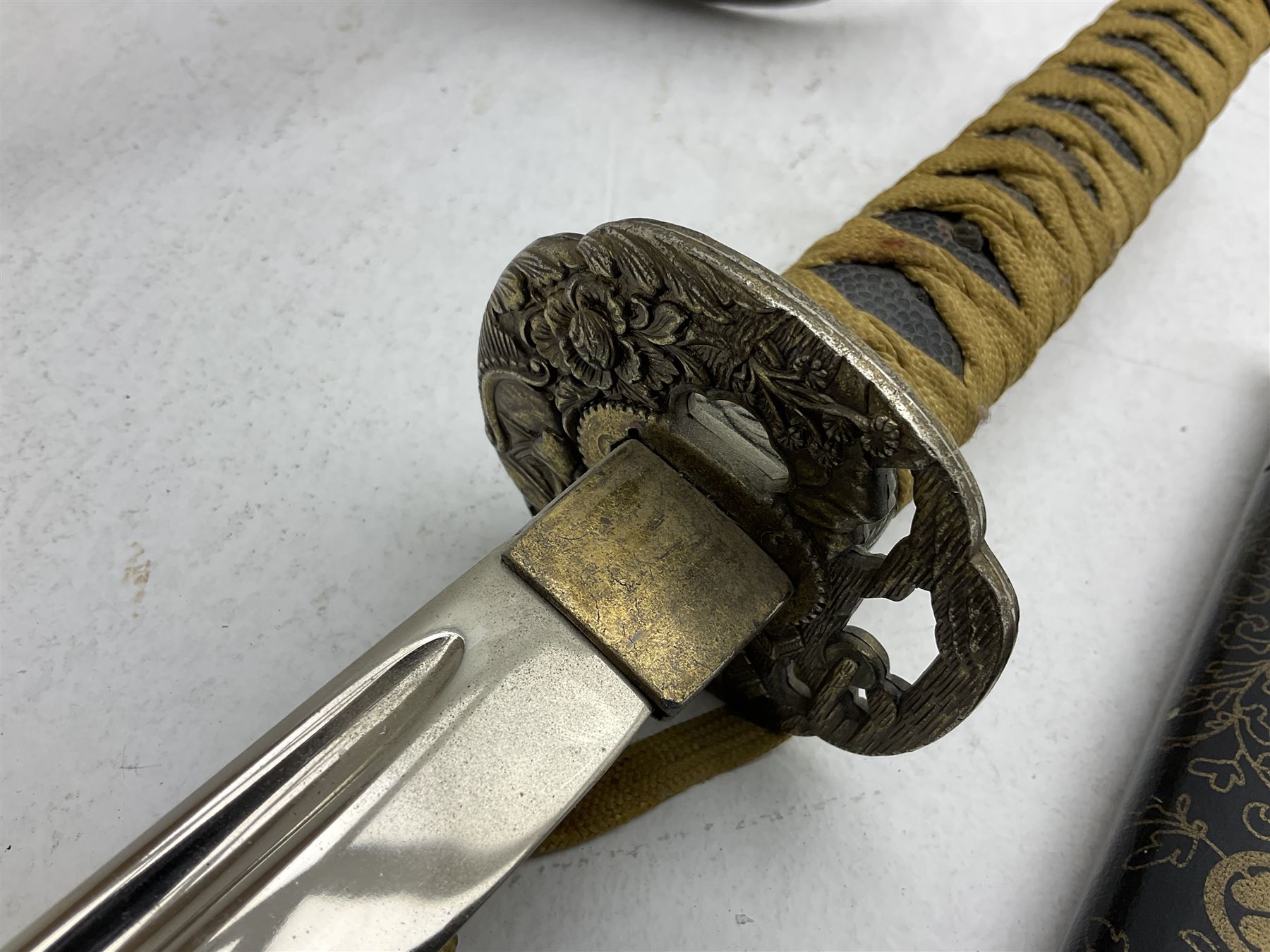 Reproduction Japanese katana with 63cm slightly curving fullered steel blade, ornate tsuba, cord bound grip and gilt transferred black saya L92cm; and two fencing foils, one marked Leon Paul (3)