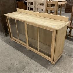 19th century pine cabinet, raised shaped back over rectangular top, enclosed by two sliding glazed doors, on turned feet - THIS LOT IS TO BE COLLECTED BY APPOINTMENT FROM THE OLD BUFFER DEPOT, MELBOURNE PLACE, SOWERBY, THIRSK, YO7 1QY