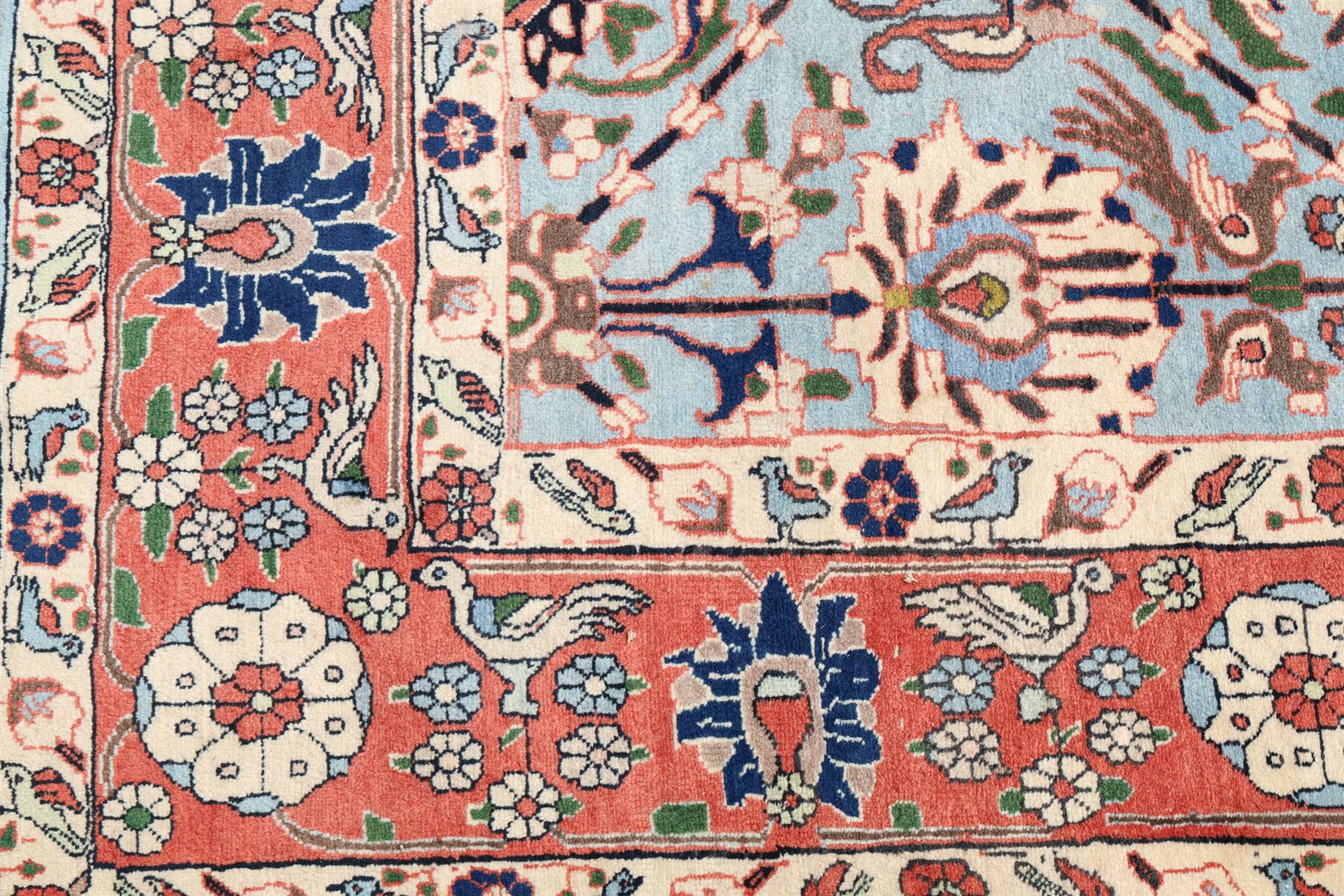 Persian Tabriz cyan ground rug of Benlian design, the field decorated with large palmette motifs, the crimson and ivory guard lines with repeating bird of paradise and interspersed stylised plant motifs
