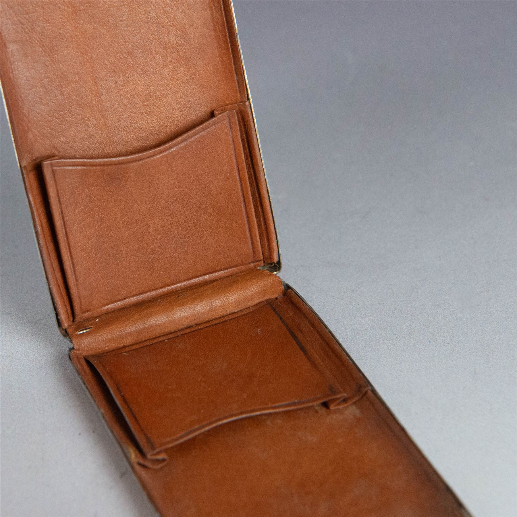 Two silver stamp cases, comprising Victorian silver mounted example with leather interior and engraved monogram to cover, hallmarked George Unite, Birmingham 1897, and a 1920s sliding example with engine turned decoration and vacant cartouche, hallmarked Sydney & Co, Birmingham 1924