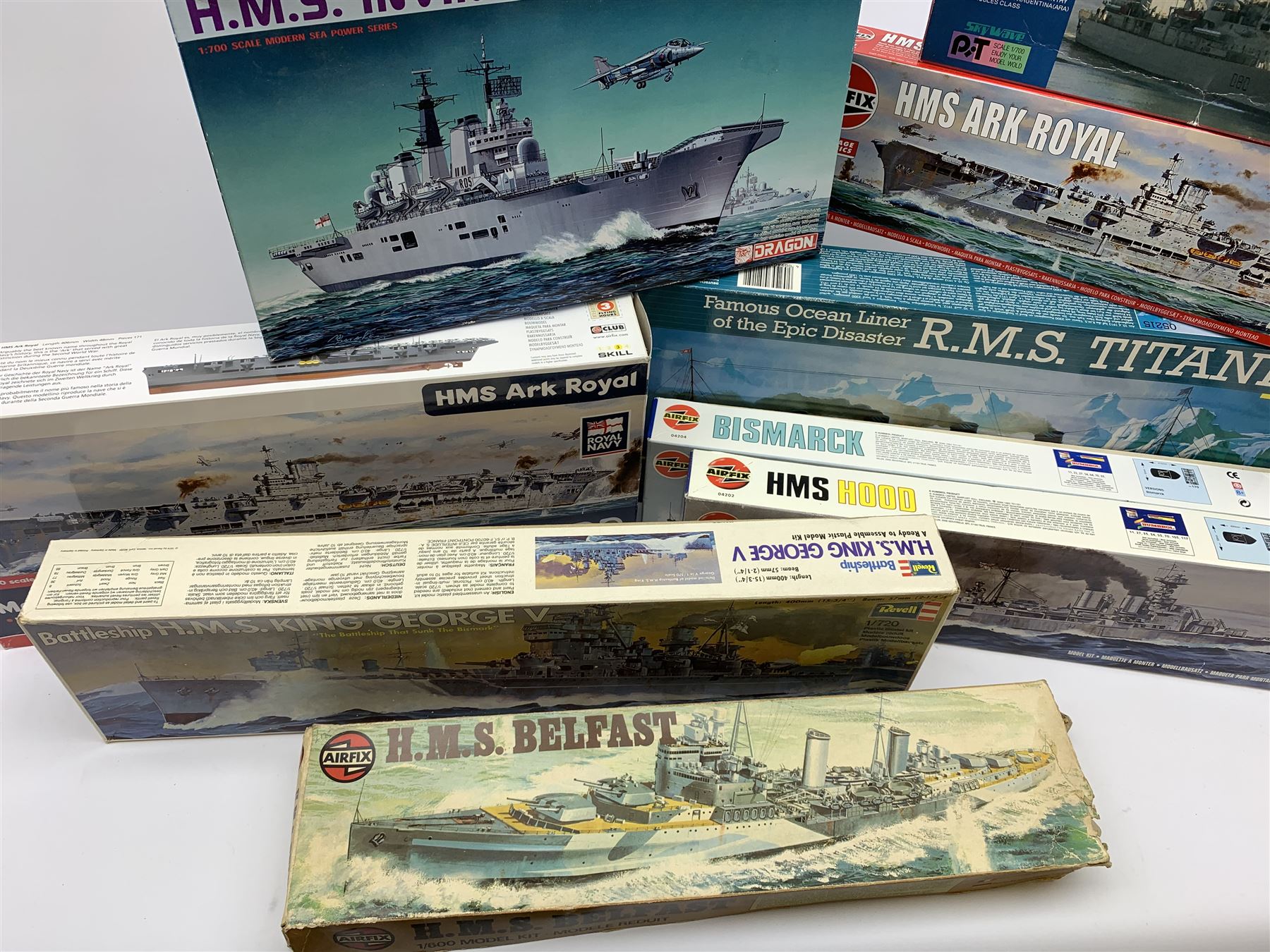 Ten plastic model kits of ships by Airfix, Revell, Dragon and Skywave, predominantly 1/600th scale including R.M.S. Titanic, HMS Invincible, two x HMS Ark Royal, HMS Fearless, HMS Hood, HMS Belfast, Bismarck etc; all boxed, most in factory sealed transparent packaging (10)