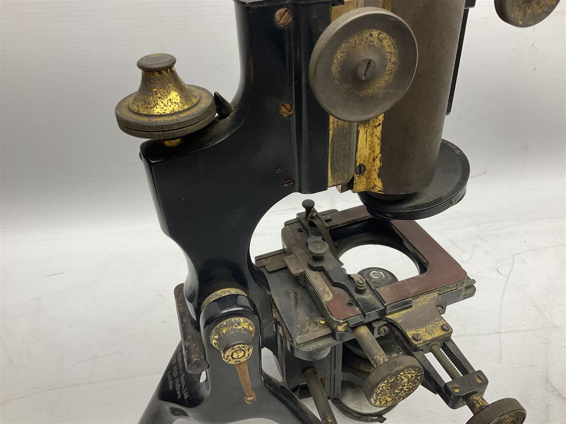 19th century brass and black japanned monocular microscope by W. Watson & Sons Ltd. 313 High Holborn, London serial no.24788 with rack and pinion focussing on tripod base H31cm; in fitted mahogany case retailed by A.H. Baird Scientific Instrument Makers Edinburgh; quantity of additional lenses and accessories; together with another similar uncased monocular microscope by W. Watson serial no.58379 (2)