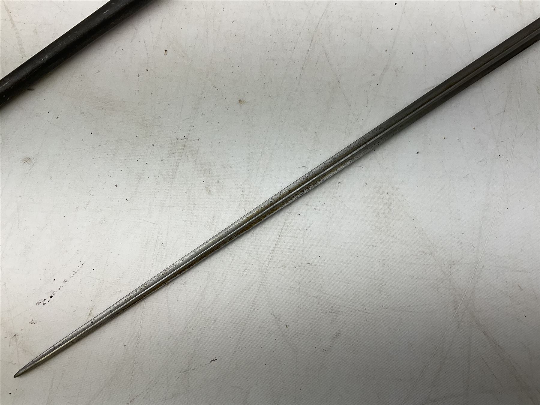 French Lebel Model 1886/93/16 bayonet with 52cm steel cruciform blade and brass hilt No.R22136; in steel tapering round scabbard numbered A62918 L65.5cm overall