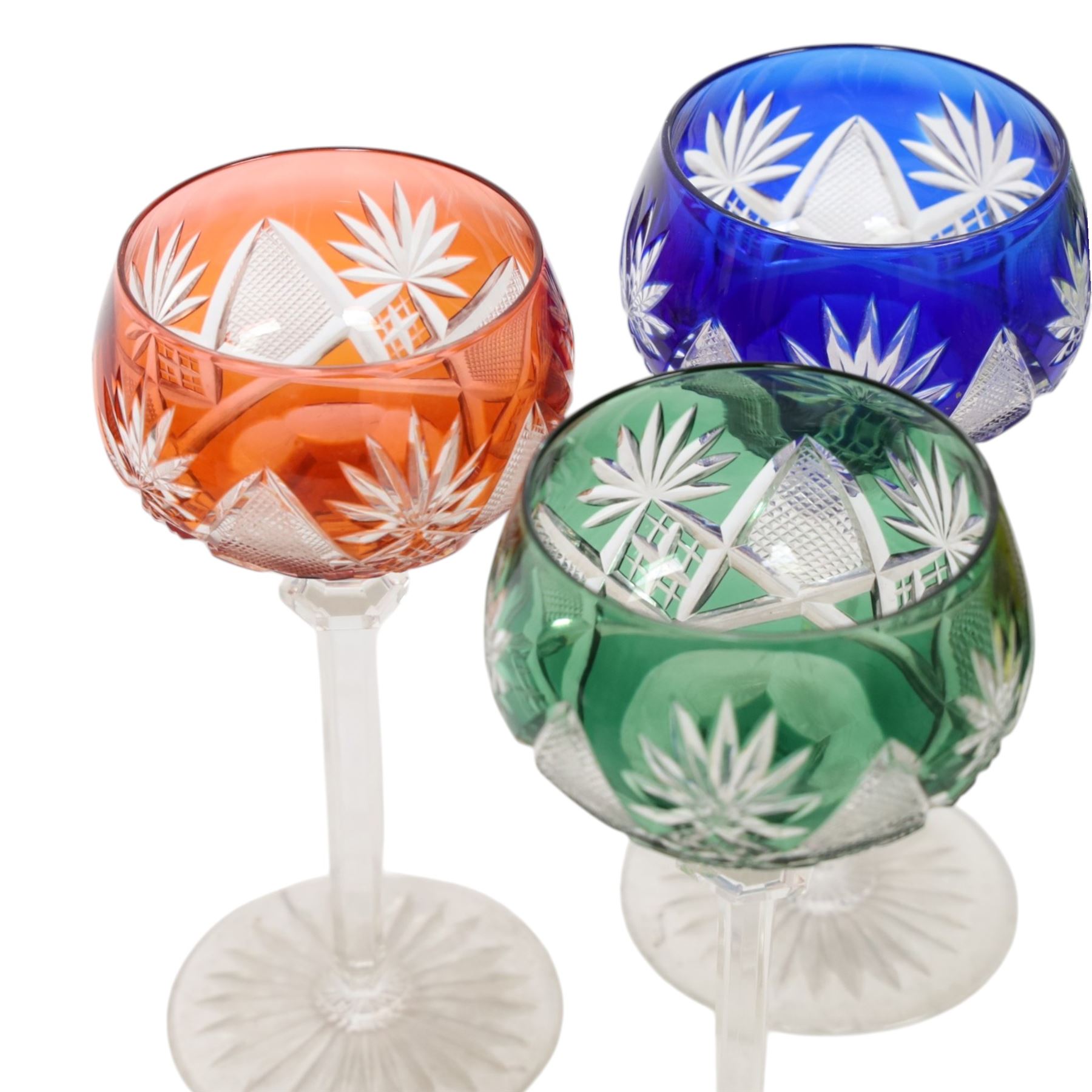 Set of six 20th Century Val St Lambert Berncastel style crystal glass wine glasses, in yellow, greens, red, purple and blue, flash cut with a repeat diamond and plume pattern above a knopped cut stem and circular spread foot, H18cm