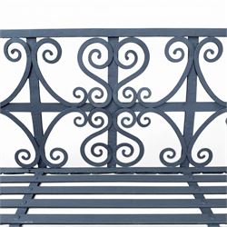 Regency period wrought iron garden bench, hand forged in wrought iron and finished in matt black paint, decorated with intricate scrollwork and featuring circular geometric ends, strapwork seat