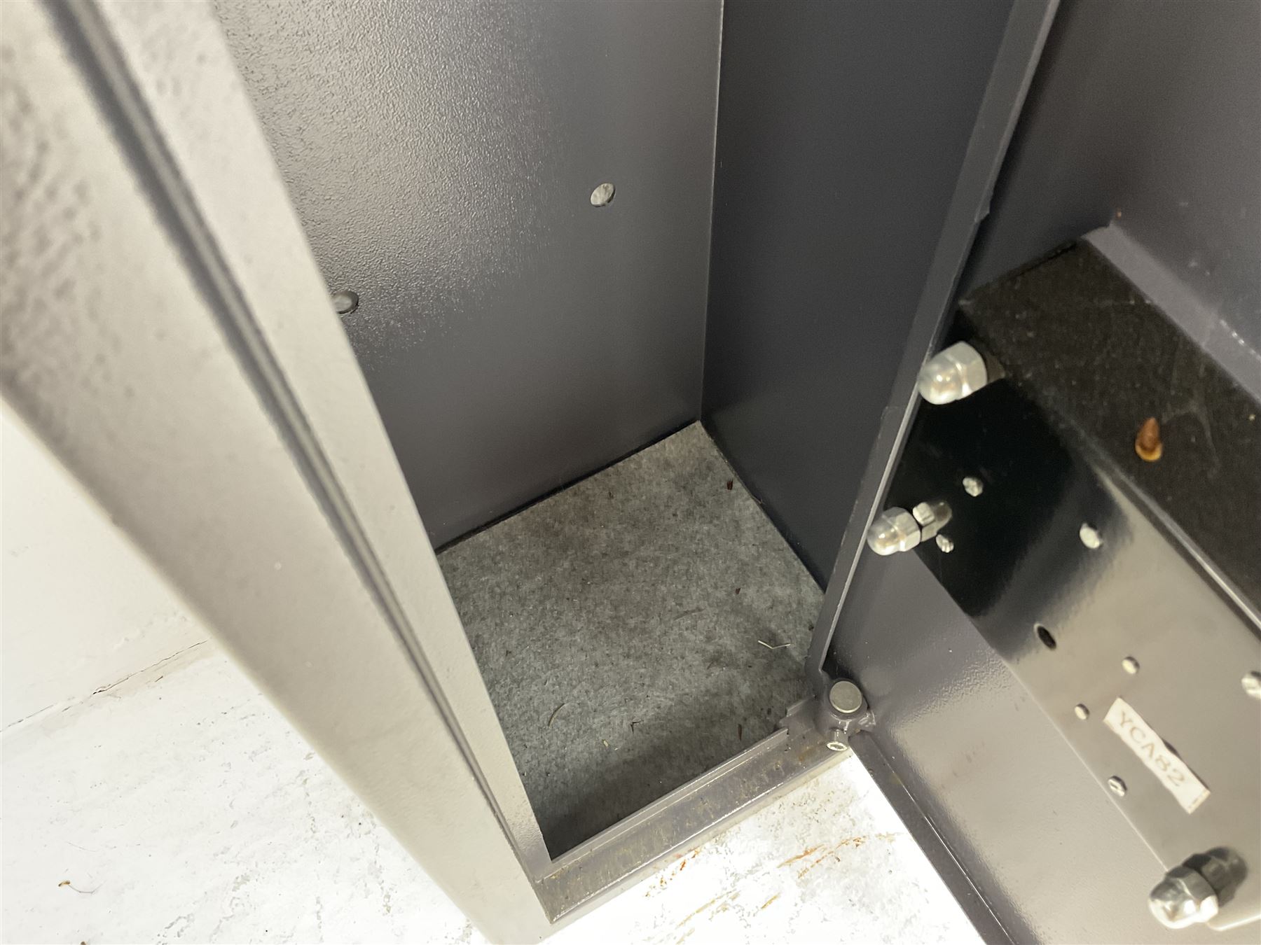 Grey steel wall mounting gun cabinet to accommodate three guns; single door with two locks with two keys for one lock; internally H128.5cm W21cm D17.5cm; externally H129cm W21.5cm D20cm