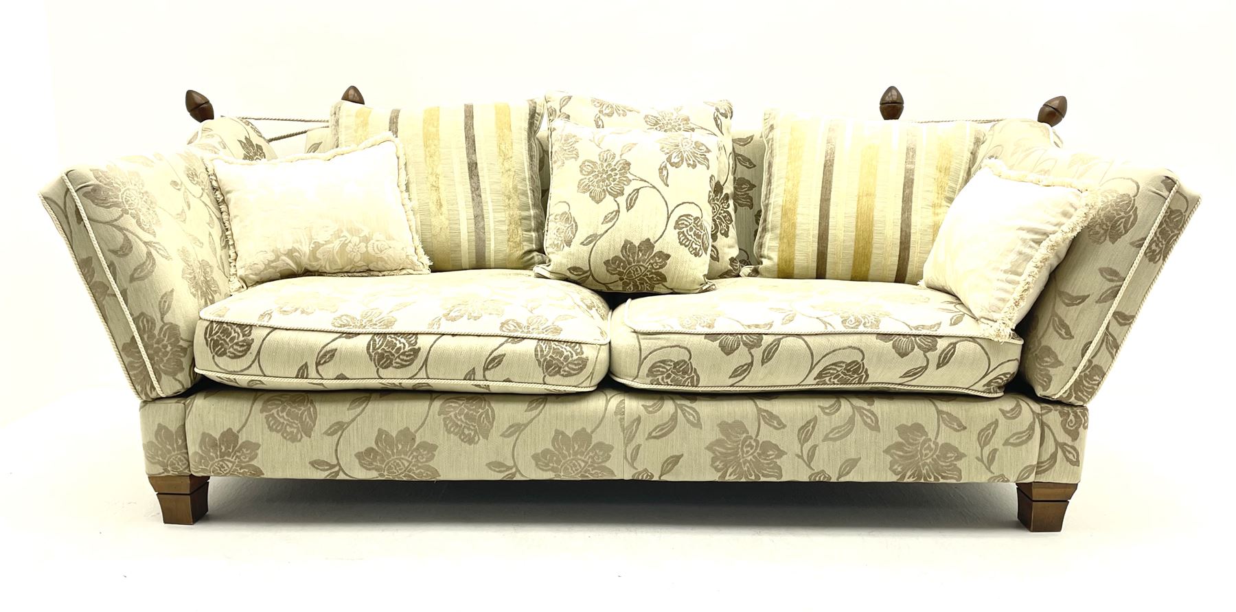 Grande Knole drop arm three seat sofa upholstered in pale fabric with raised floral pattern, with feather scatter cushions