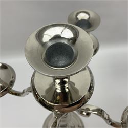 Pair of four branch candelabras, urn-shaped nozzles raised upon scroll branches supported from tapering central stem, with a stepped circular base, H40cm