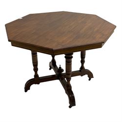 Edwardian oak centre table, octagonal moulded top on quadruple turned pillar supports, on x-framed platform terminating into curved feet, central turned finial