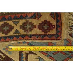 Two Caucasian designed rugs comprising a flatweave and hand-knotted rug, Caucasian design flatweave, cream ground with three large blue geometric medallions surrounded by stylised birds and geometric motifs, enclosed by repeating geometric border, fringed ends, H176cm, W102cm; hand-knotted Caucasian rug, ivory ground with three polychrome octagonal medallions surrounded by stylised animals, flowerheads and geometric motifs, enclosed by salmon pink geometric border, fringed ends, H163cm, W106cm