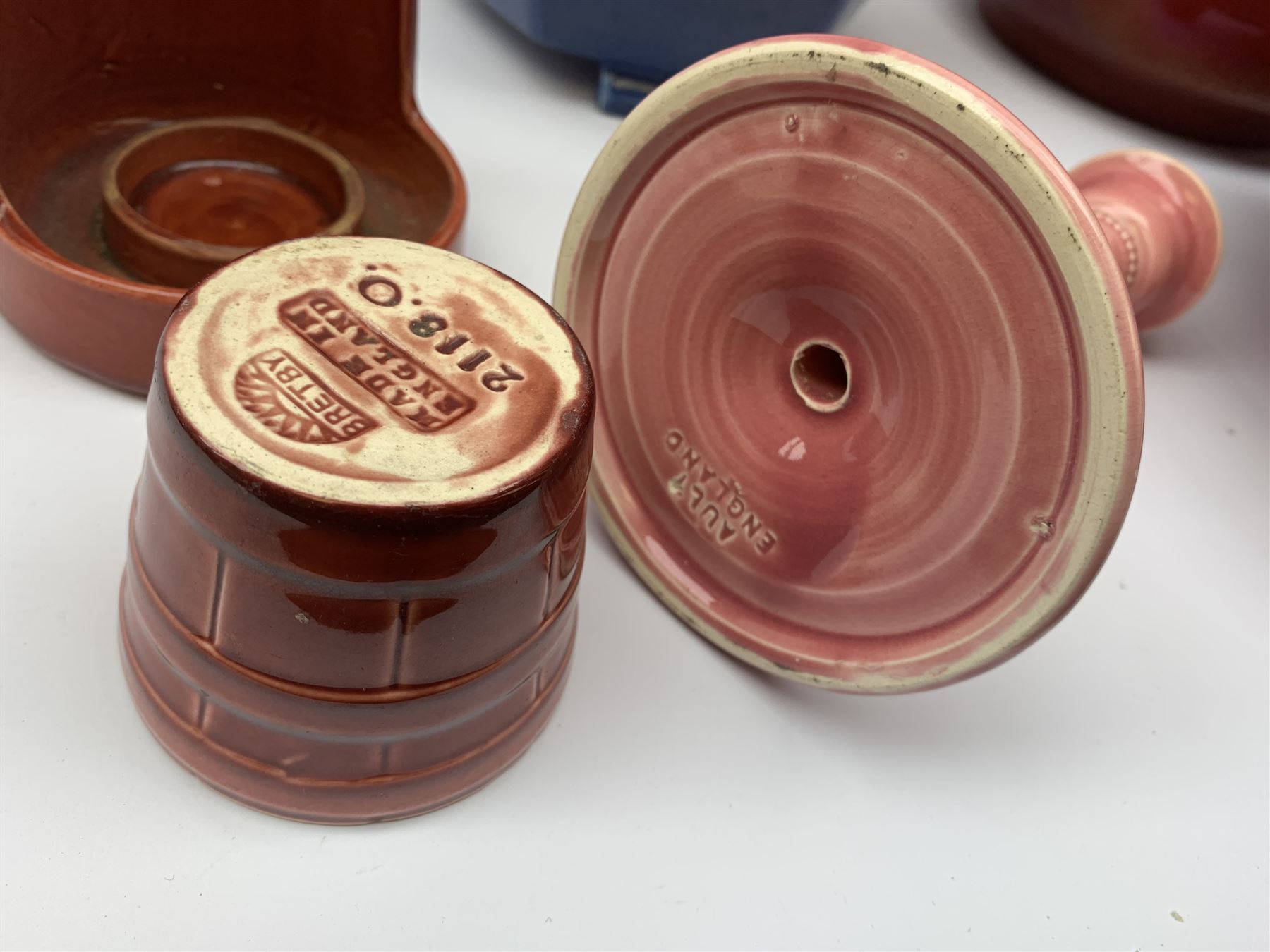 Two Bretby jardinières, hexagonal planter and trumpet shaped vase,  preserve pot and chamberstick together with an Ault pink glazed candlestick and low comport (8)