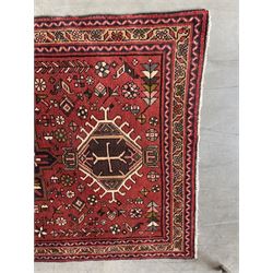 Persian Karajeh red ground runner, decorated with multiple stylised medallions and motifs