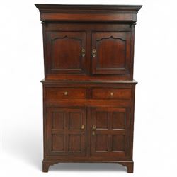 Early 19th century Welsh oak kitchen cupboard, the projecting cornice with twin cupboard doors, the rectangular base over two frieze drawers and panelled cupboard doors, raised on bracket feet, with fielded and arched panel variants to front and sides