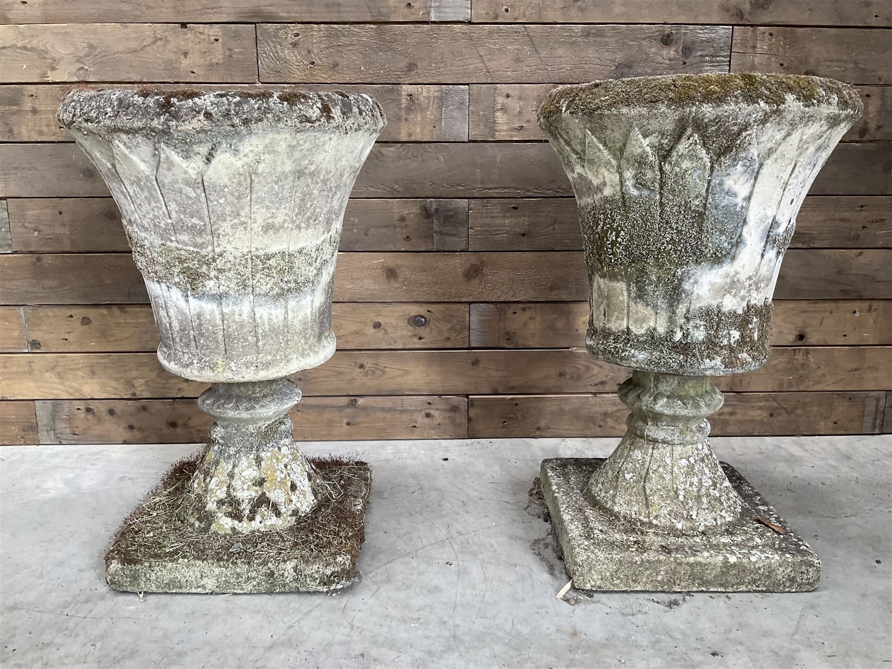 Pair of Regency design weathered cast stone garden urns